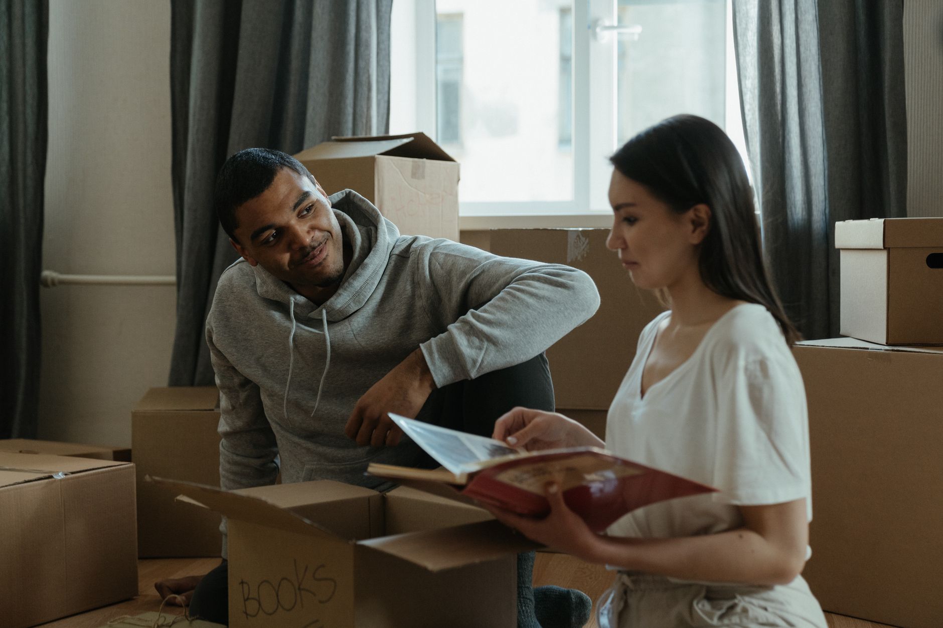 Family moving boxes into a smaller home - representing migration patterns