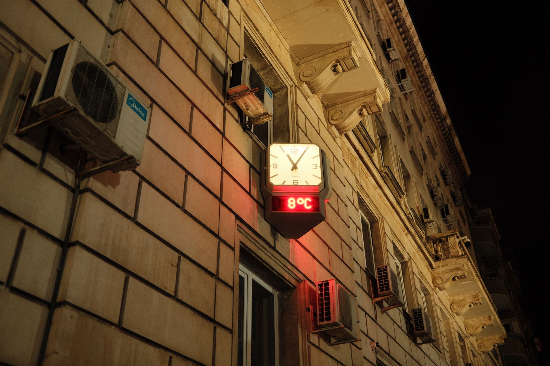 Overheated social housing flat with thermometer showing high temperature