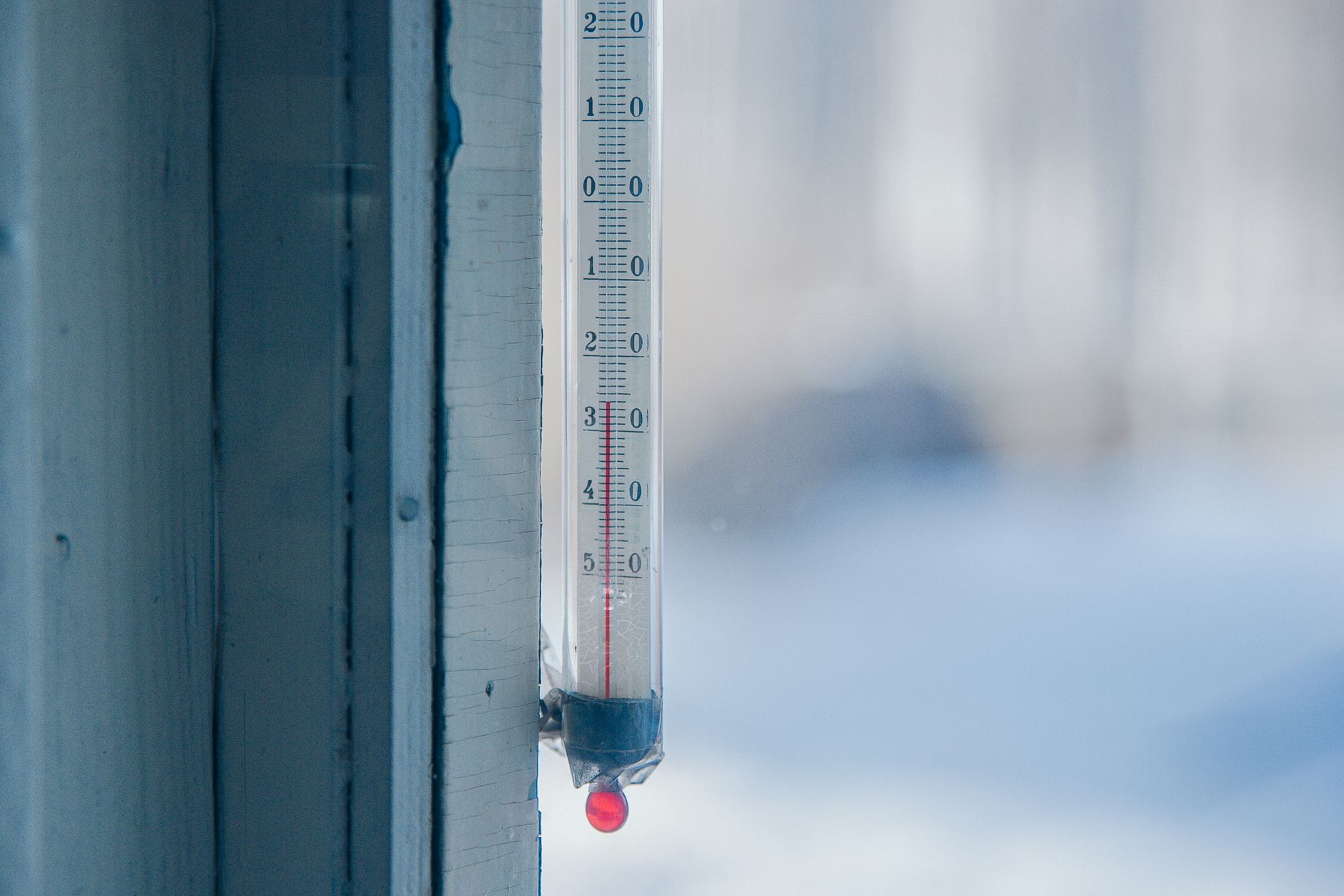 Thermometer showing high temperature next to open window