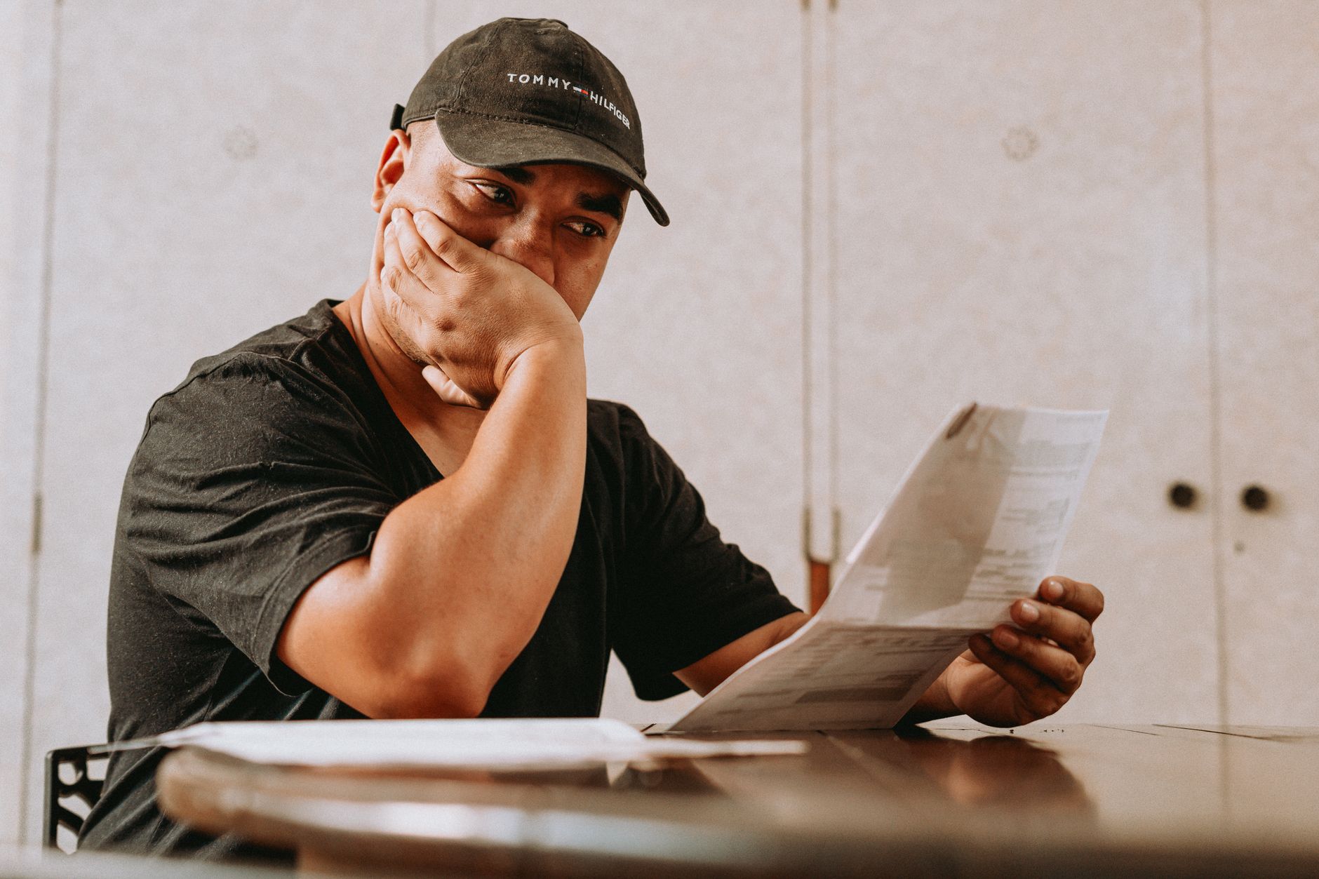 Tenant reviewing rent increase letter with concerned expression