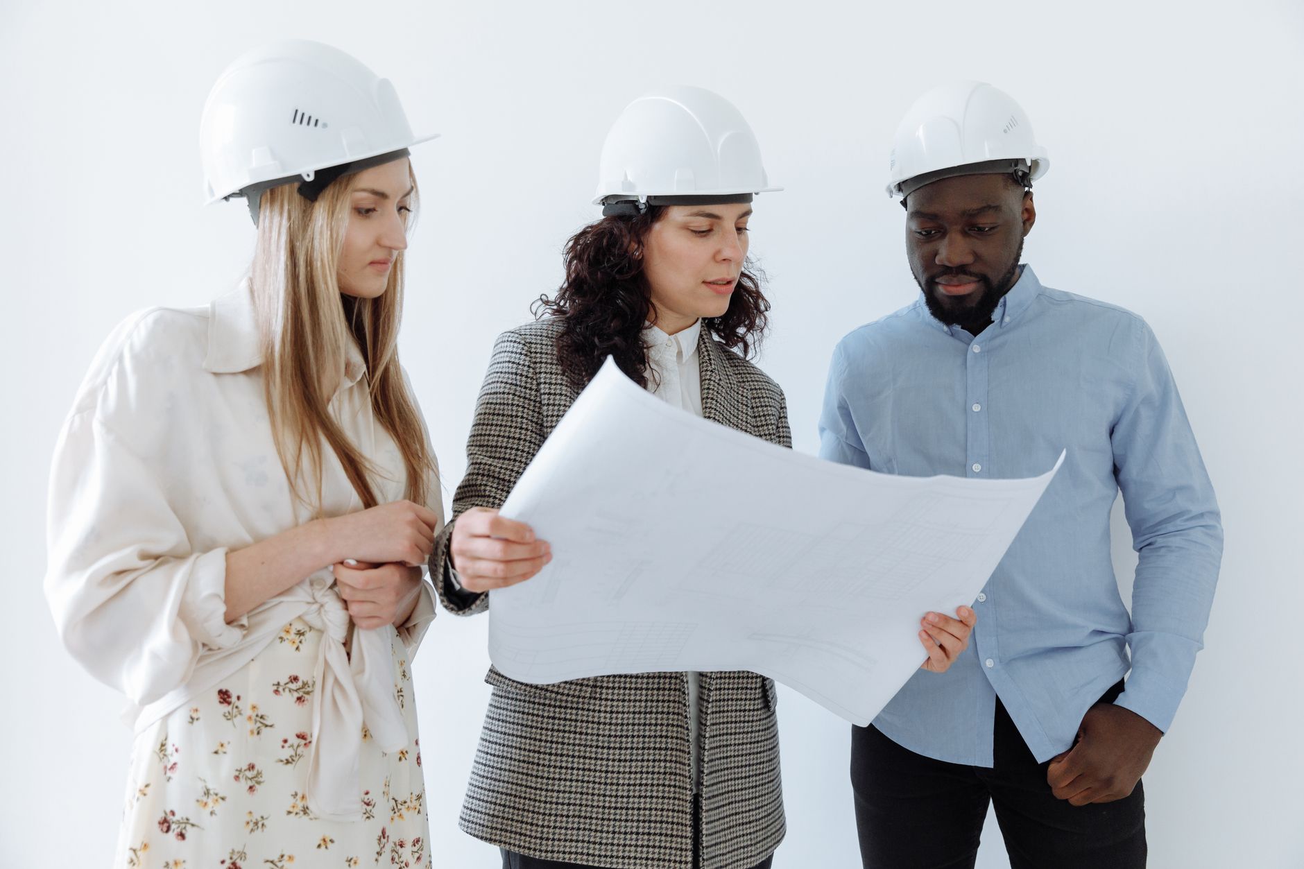Group of housing professionals reviewing architectural plans