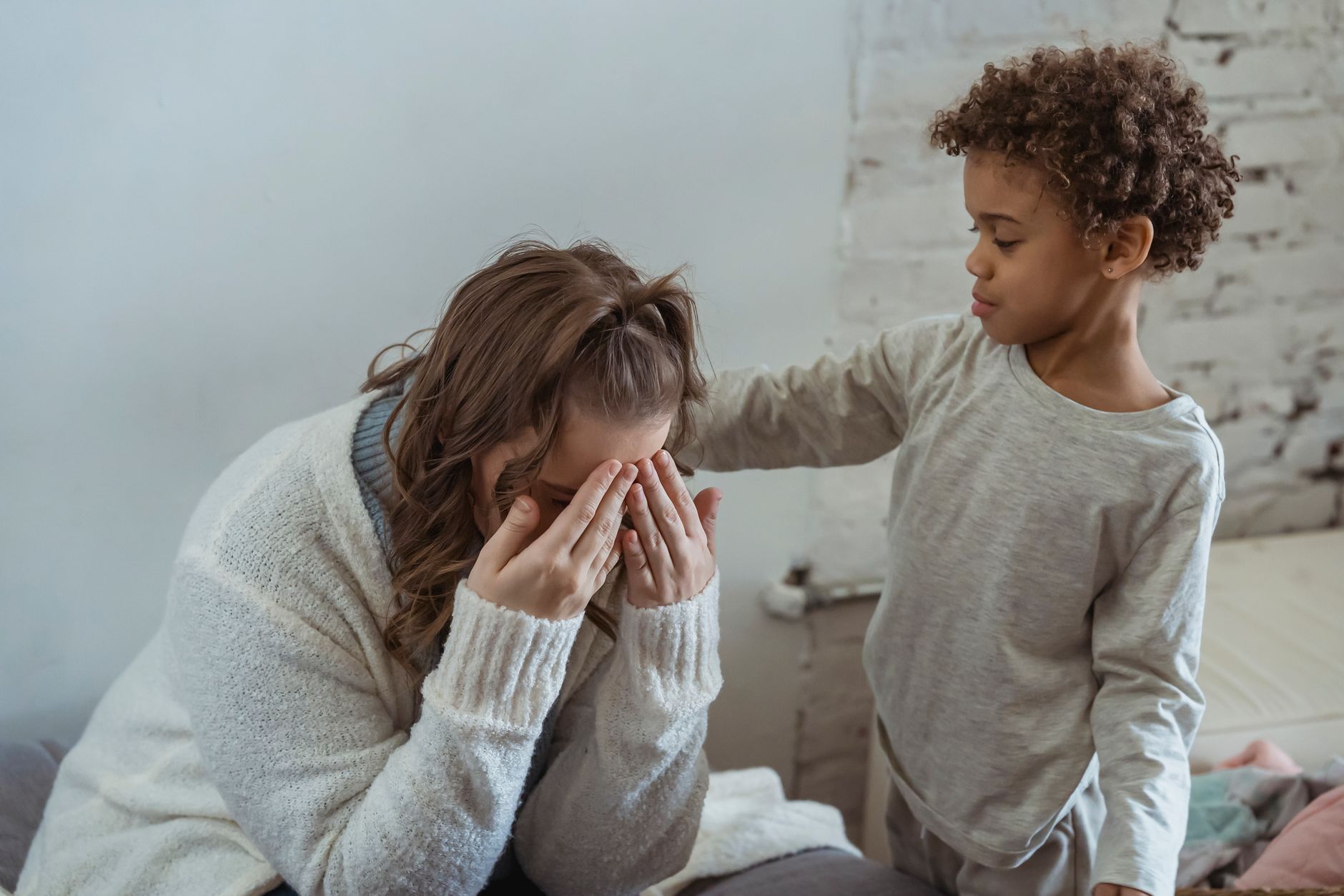 Family in social housing during heatwave - distressed mother and child in warm apartment