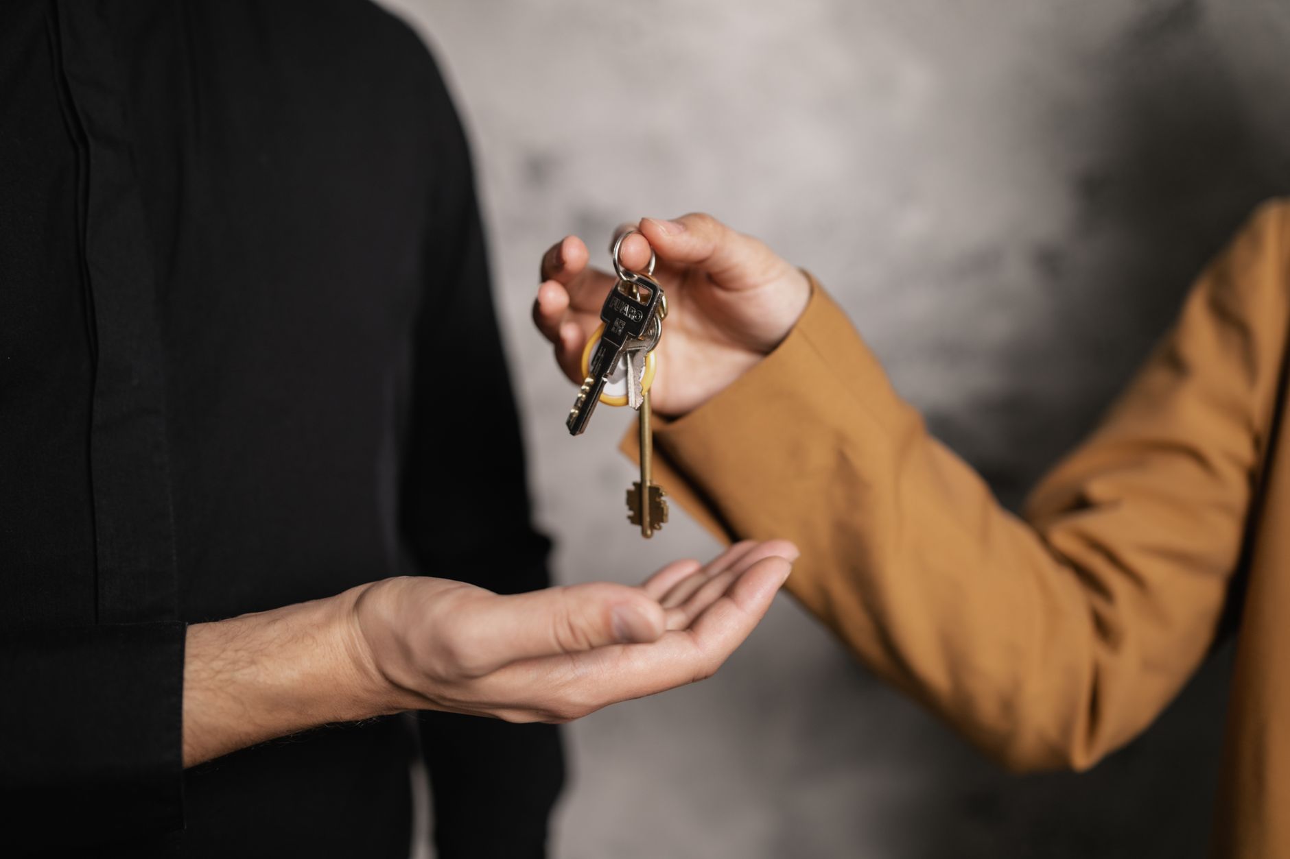 Close-up of keys being handed over in a social housing tenancy agreement