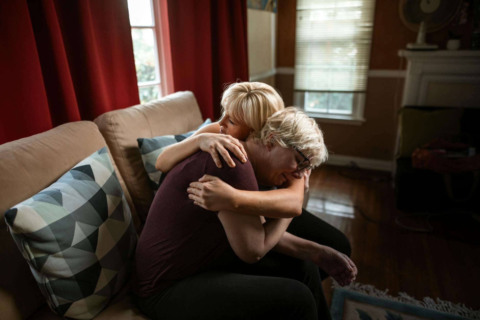 Support worker comforting domestic abuse survivor