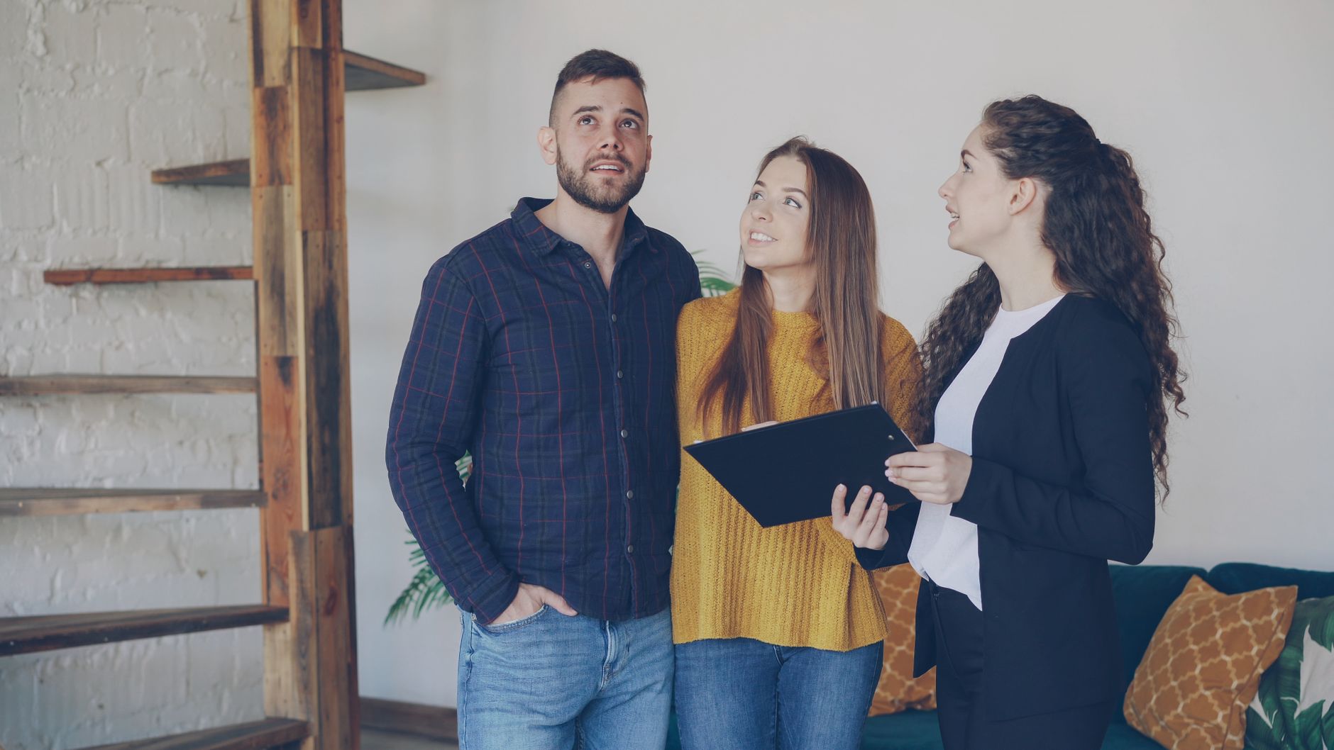 First-time buyers looking at property listings on laptop