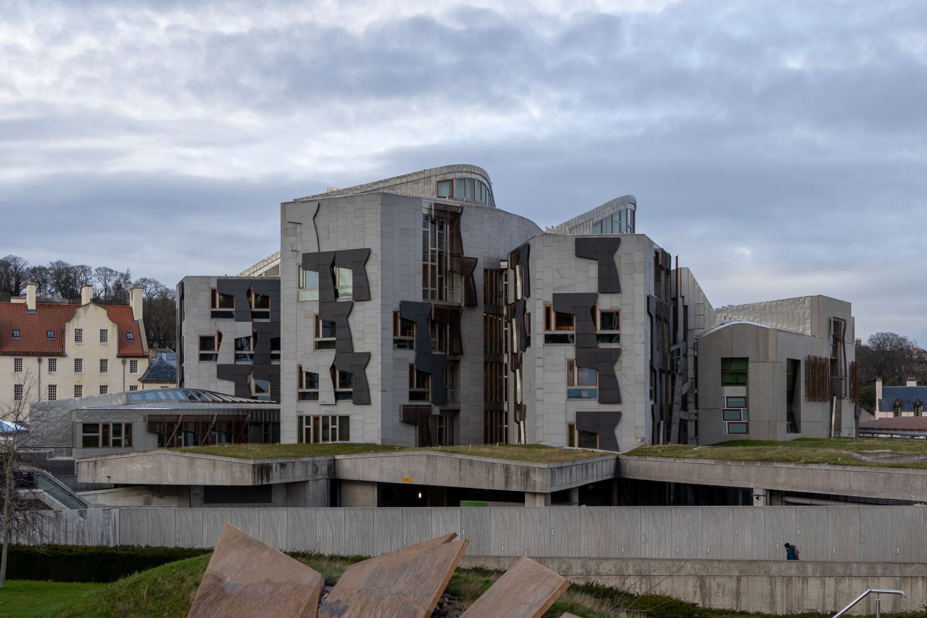Scottish Parliament building with housing policy documents