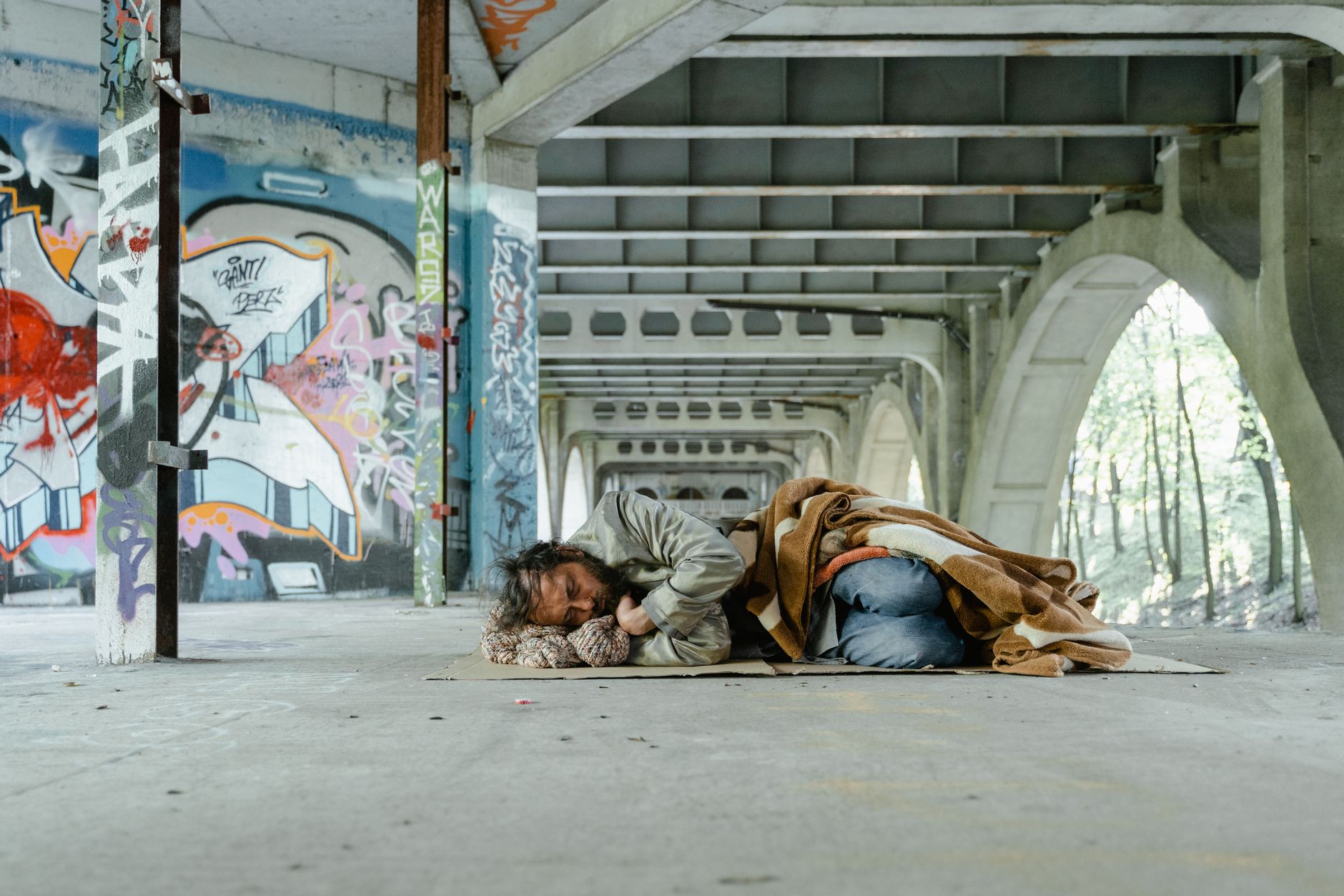 Homeless person sleeping rough in urban area