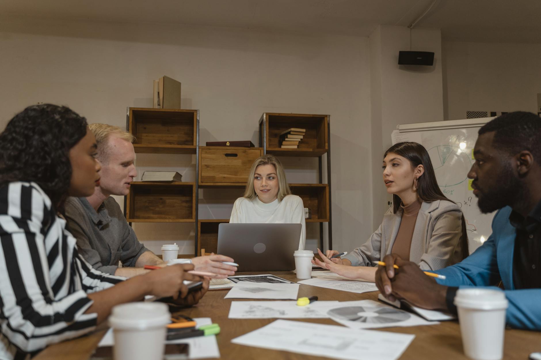 Group of housing professionals discussing plans in a meeting room