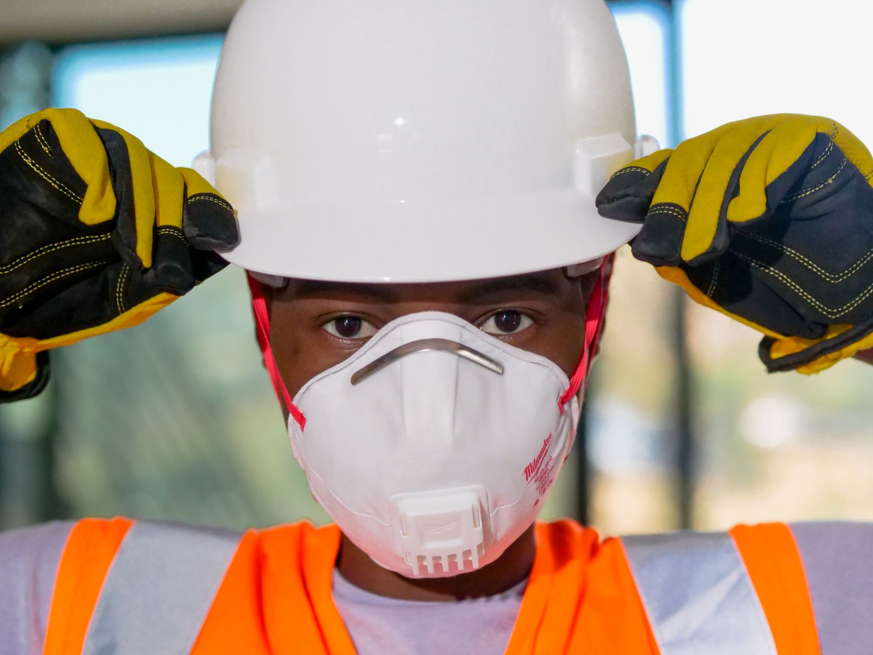 Construction worker using safety equipment - highlighting proper PPE and safe practices