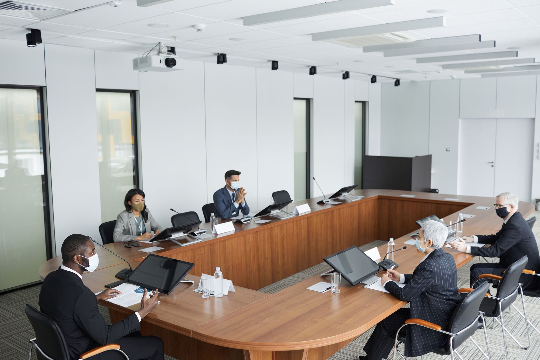 Social housing professionals in a meeting discussing compliance