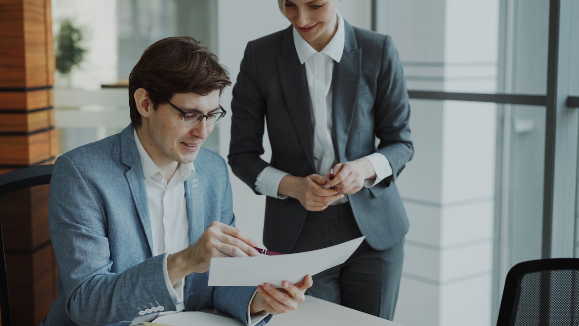 A professional property manager reviewing documents in a modern office
