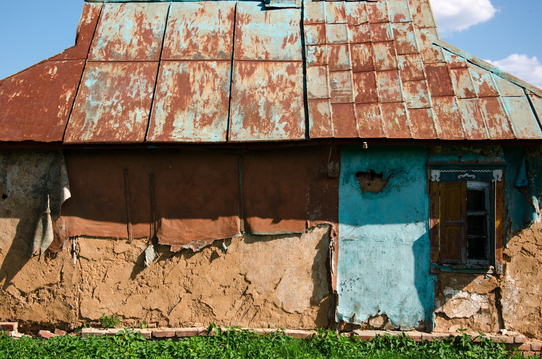 Exterior of dilapidated rental property with visible structural issues