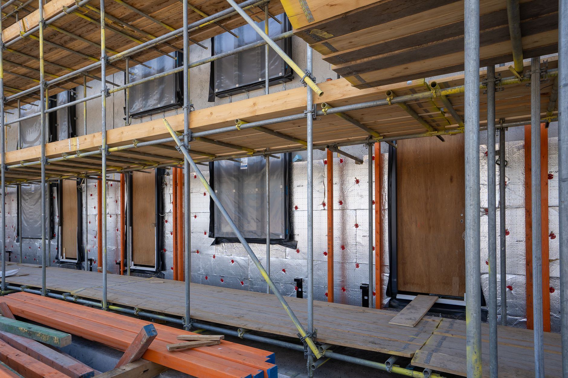 Social housing retrofit team installing insulation