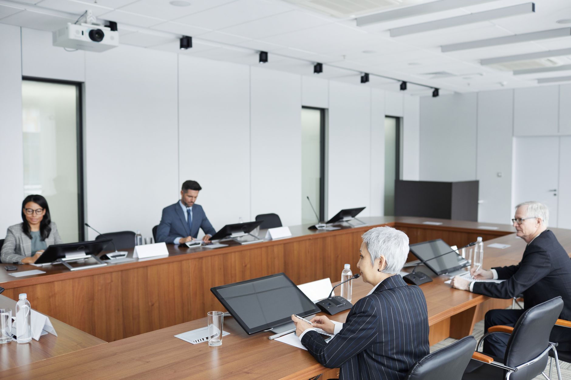 Housing association meeting - Professionals discussing social housing strategy in a boardroom