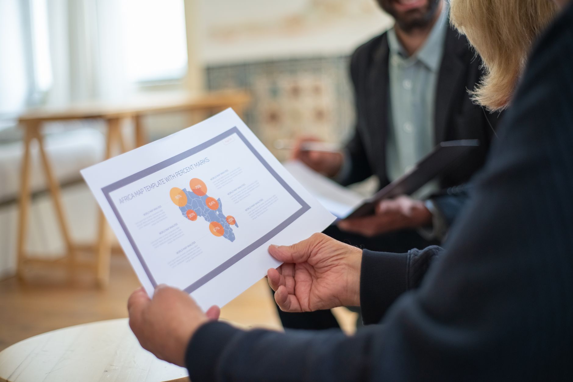 Housing association professionals reviewing regional investment maps