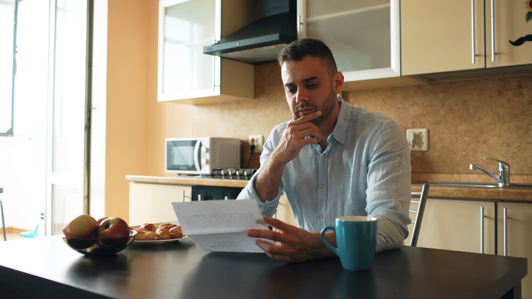 Tenant reviewing rent increase letter with concerned expression