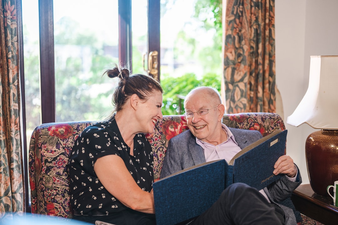 Support worker assisting elderly tenant with paperwork