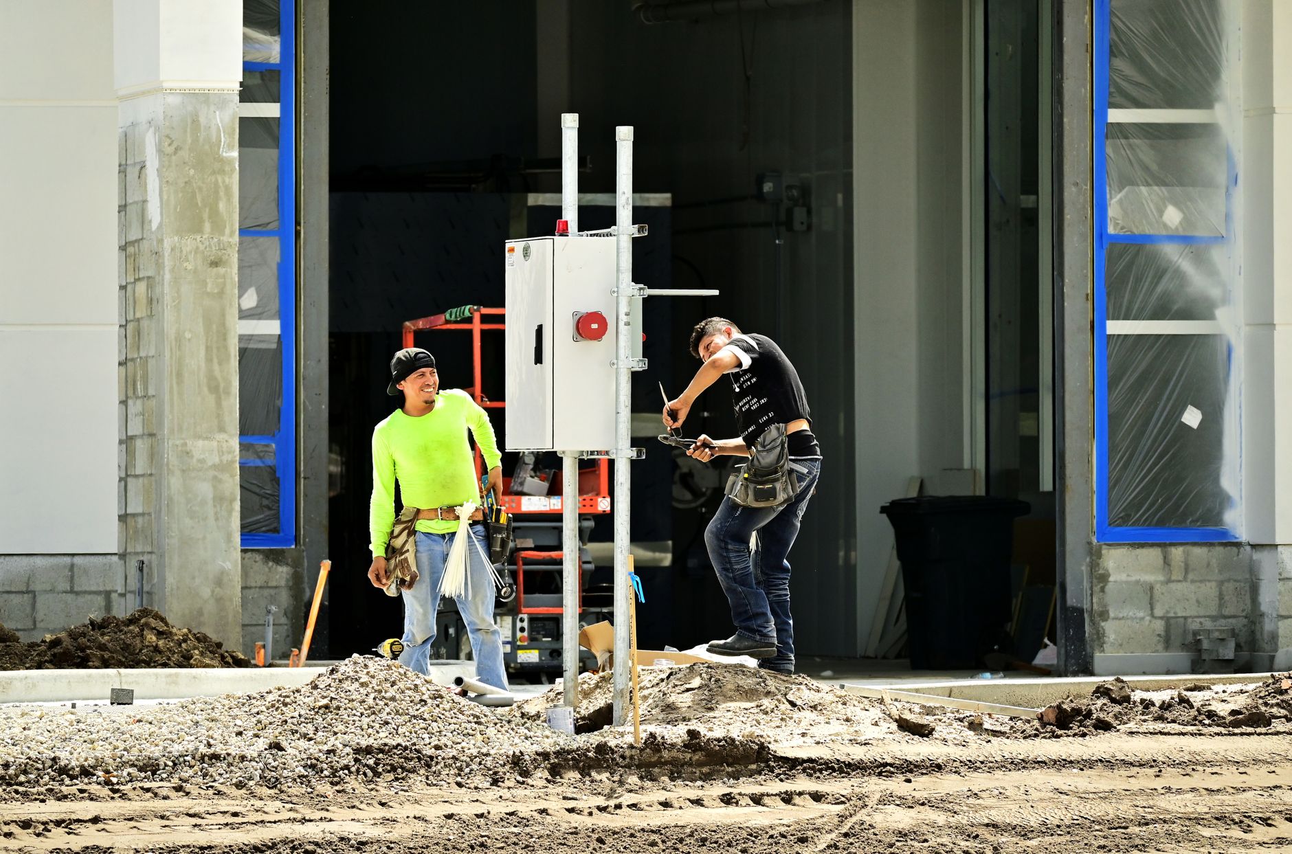 Construction workers installing fire safety equipment in residential building