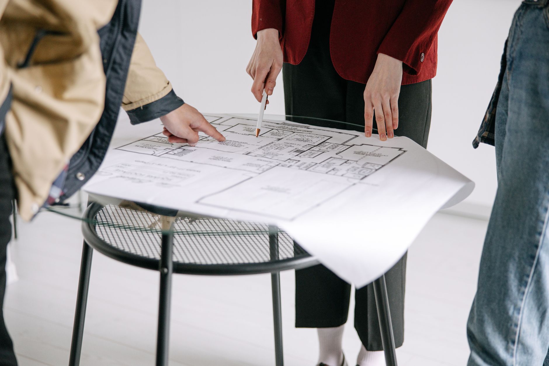 Social housing professionals reviewing property plans in a meeting room