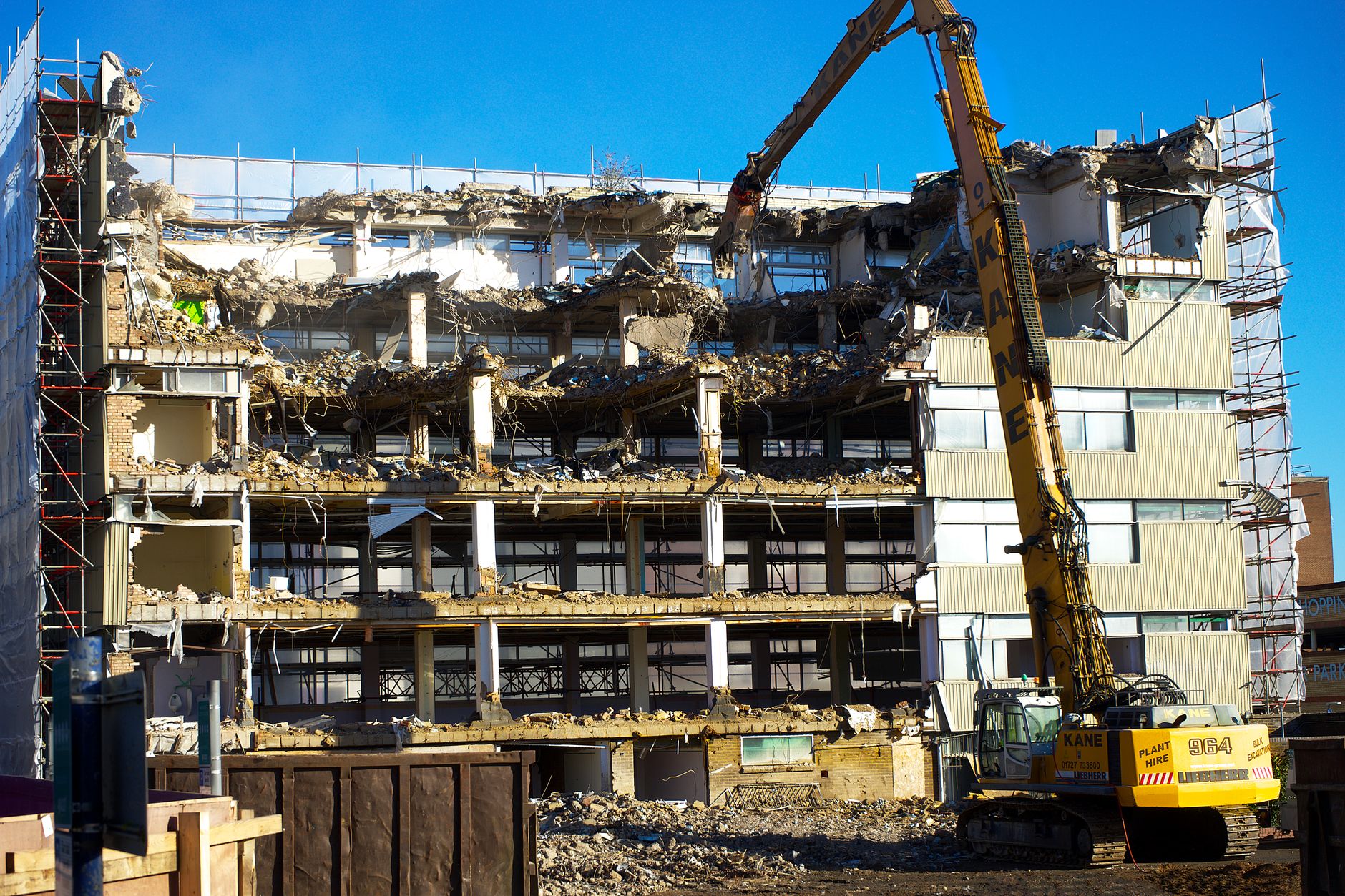 Construction workers removing cladding - showing remediation in progress