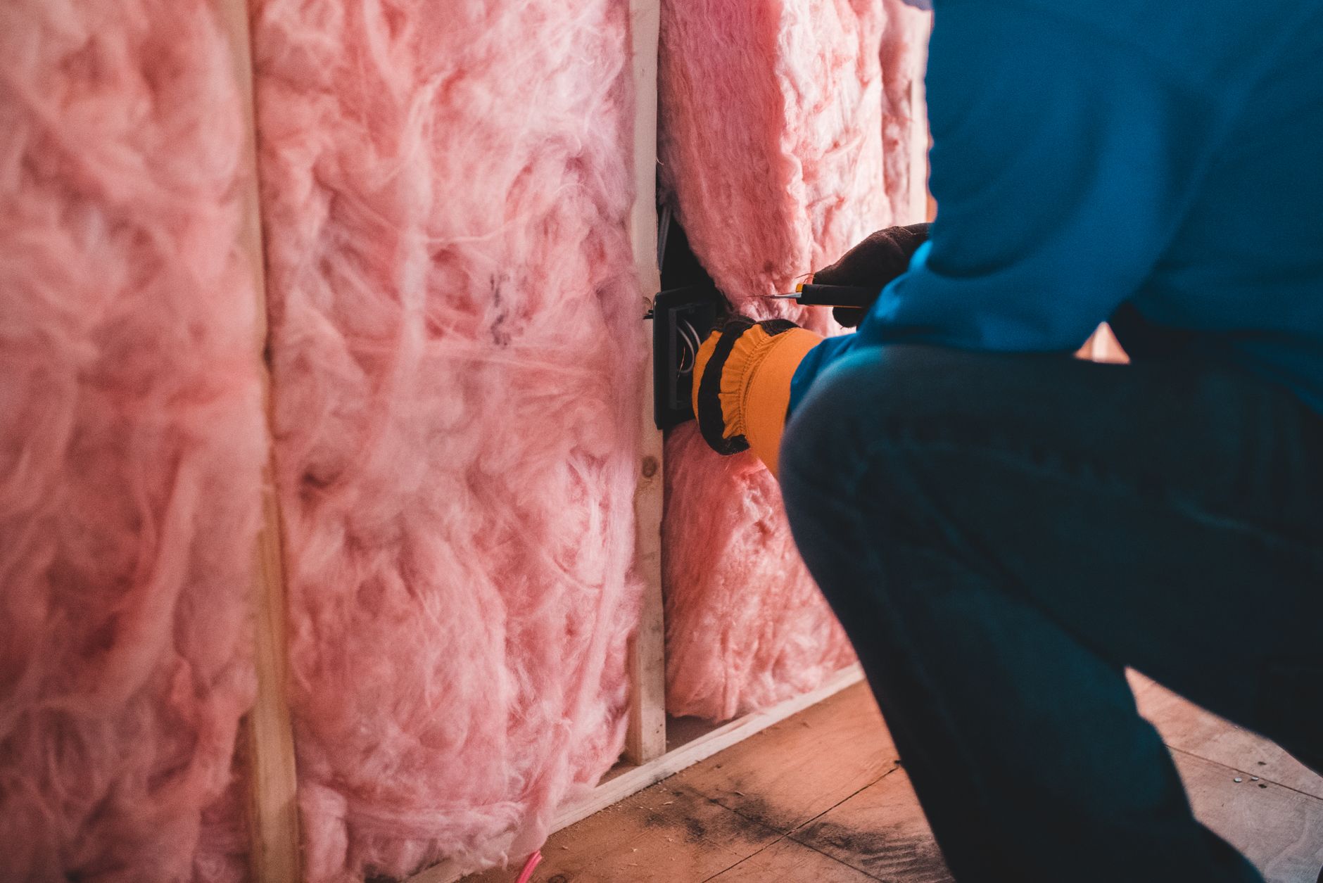 Construction workers installing insulation in social housing