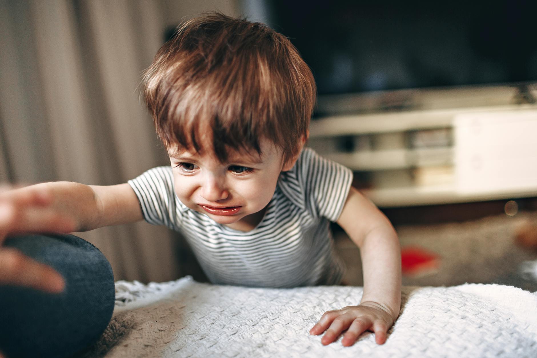 Distressed woman holding child - representing domestic abuse survivors seeking housing