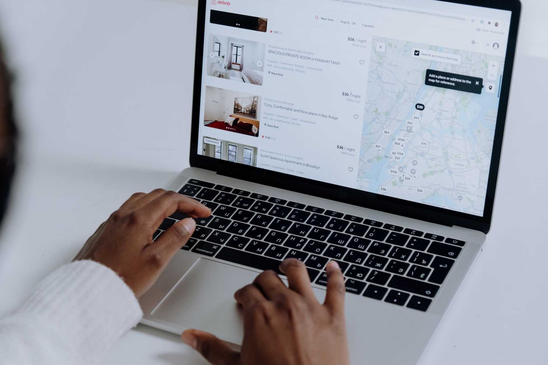 Professional reviewing property listings on a laptop