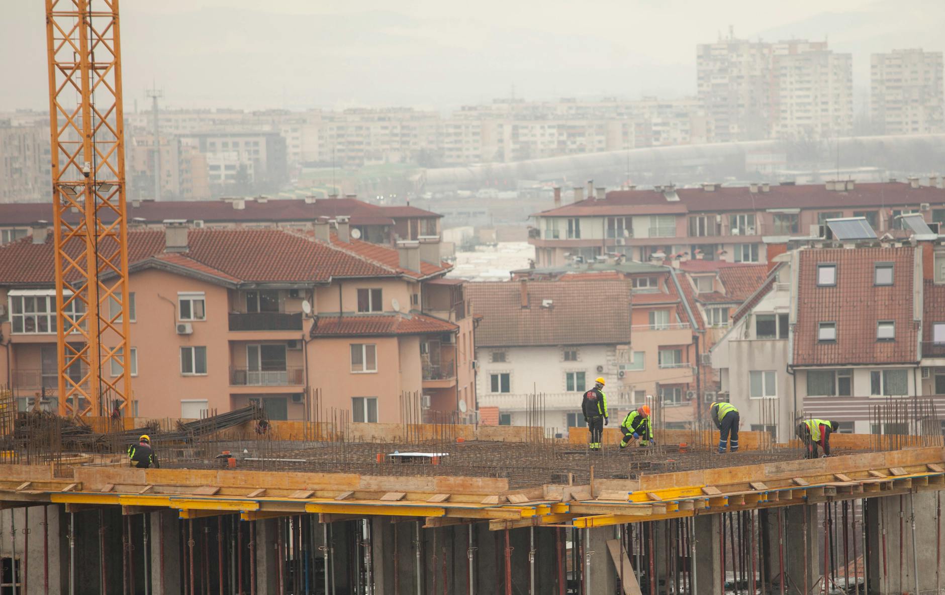 Construction site with workers building social housing