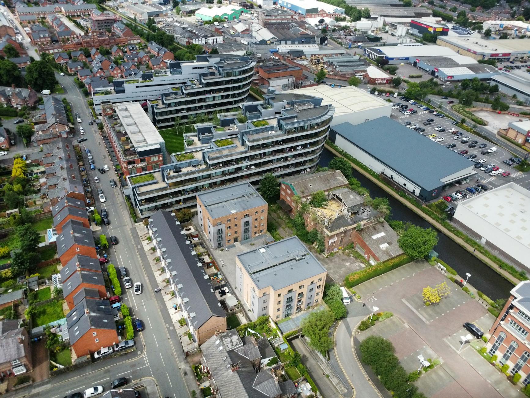Aerial view of housing development in Manchester with modern apartments and green spaces