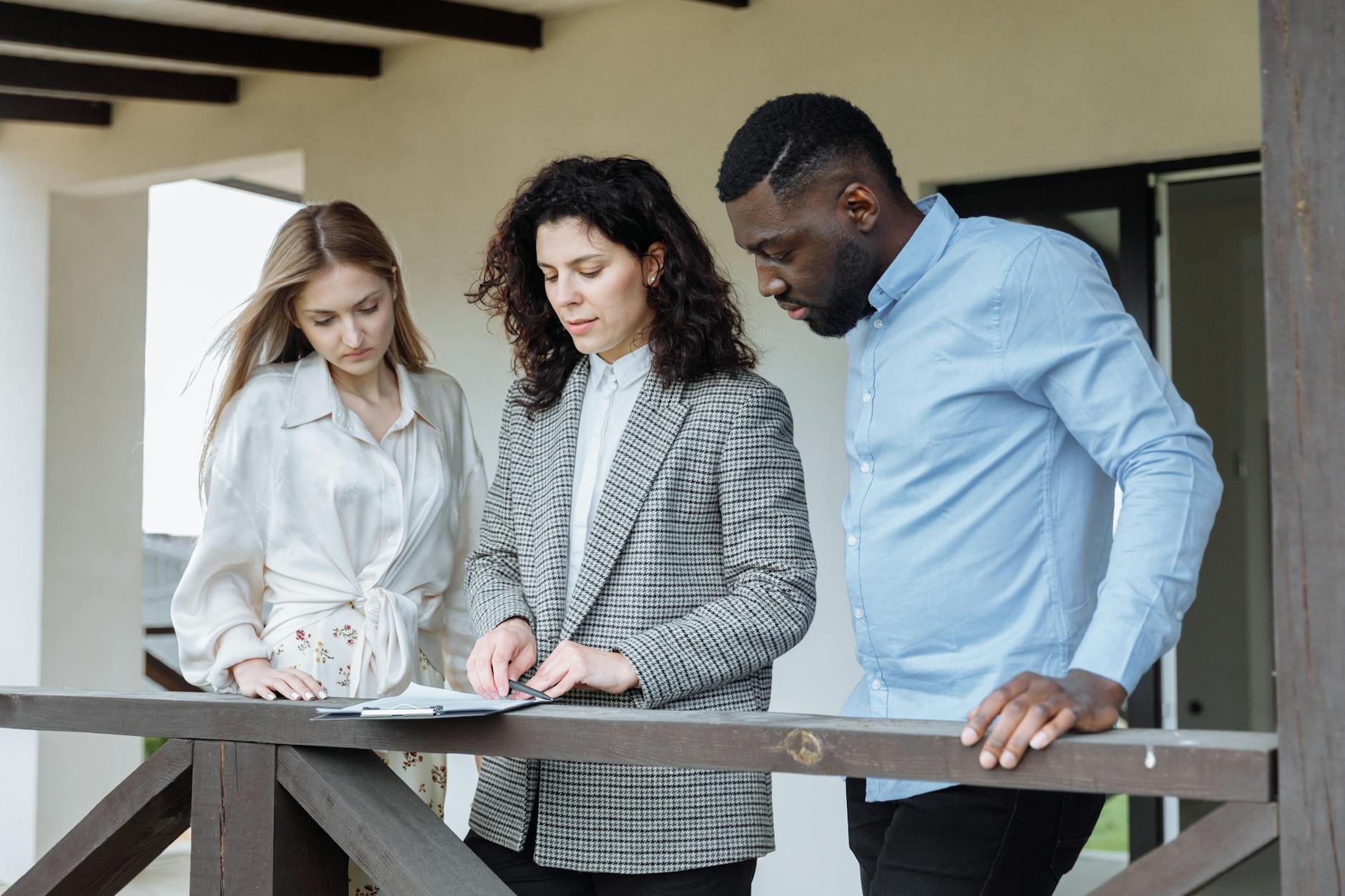 Team of housing professionals reviewing property portfolio documents
