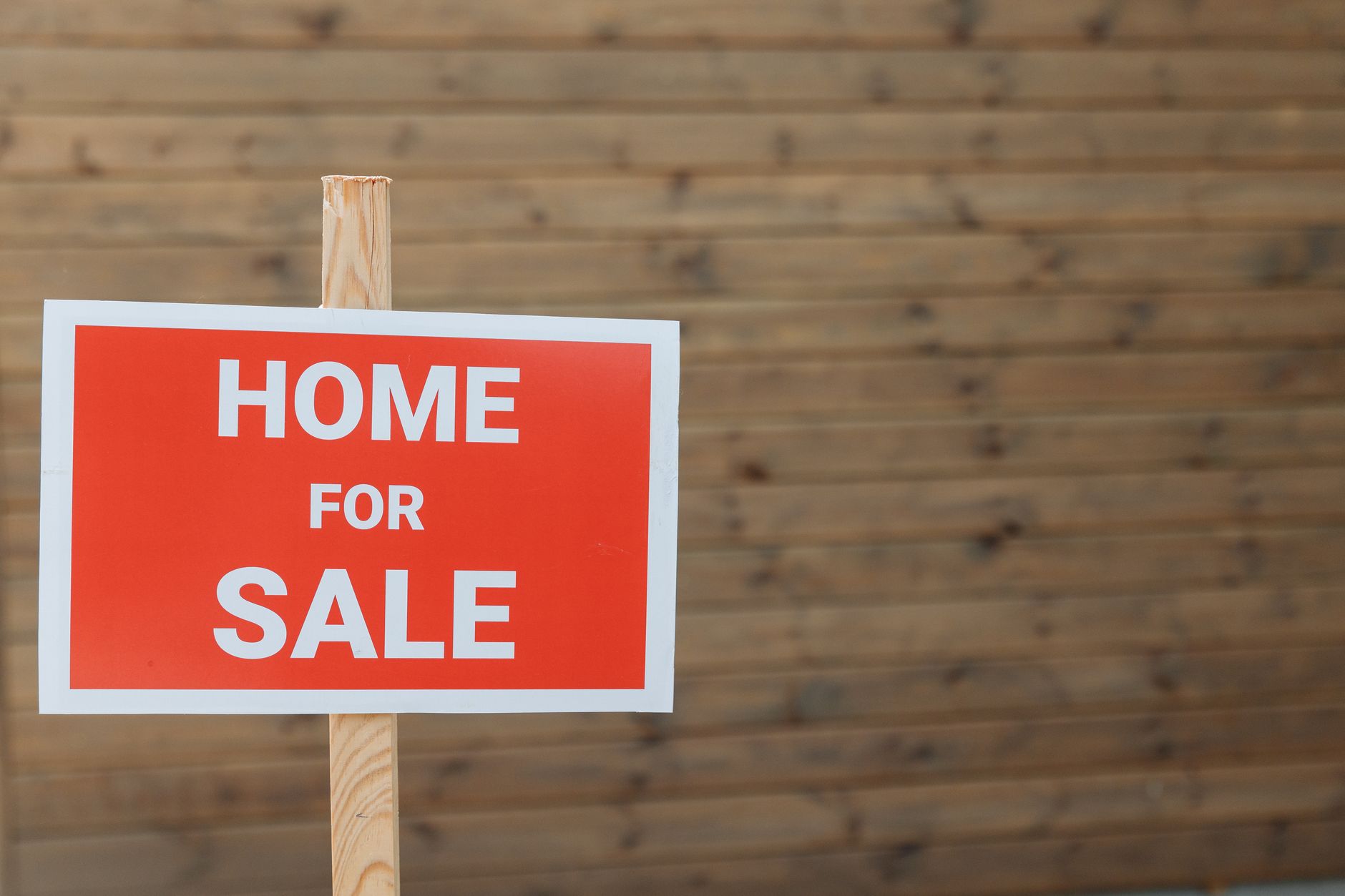 UK housing market stagnation with a 'for sale' sign and graph overlay