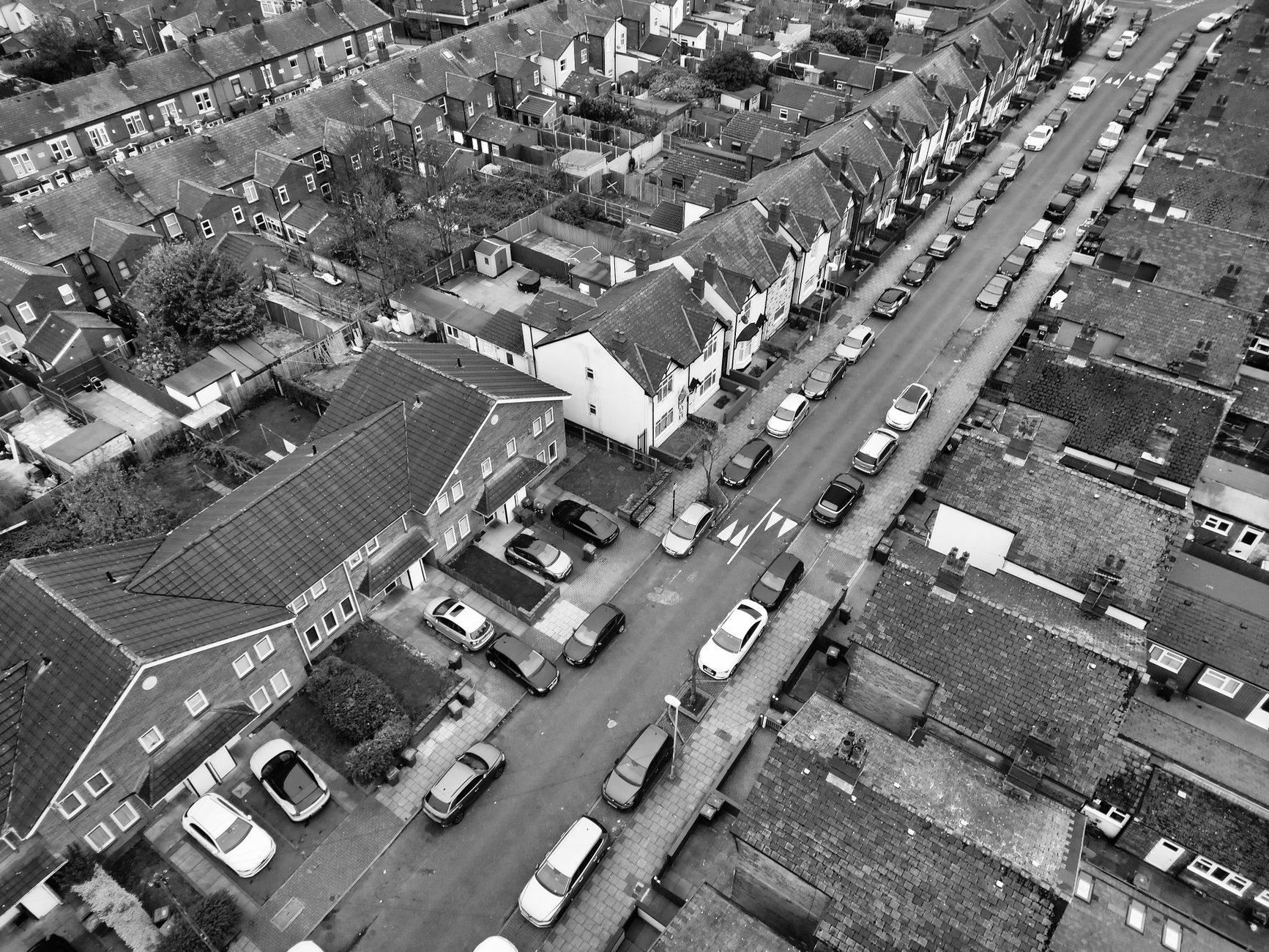 Aerial view of a mixed-tenure housing development with social housing blocks clearly marked