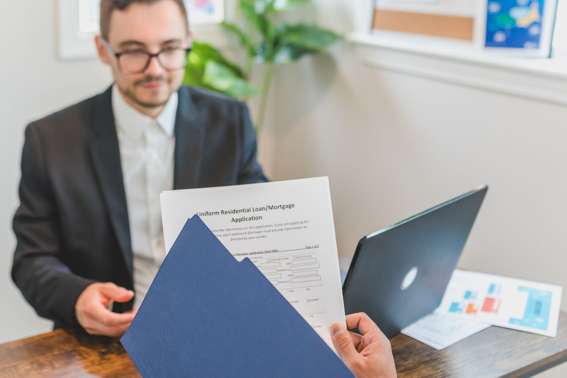 Housing officer reviewing applications - alt text: Housing professional reviewing tenant applications on laptop