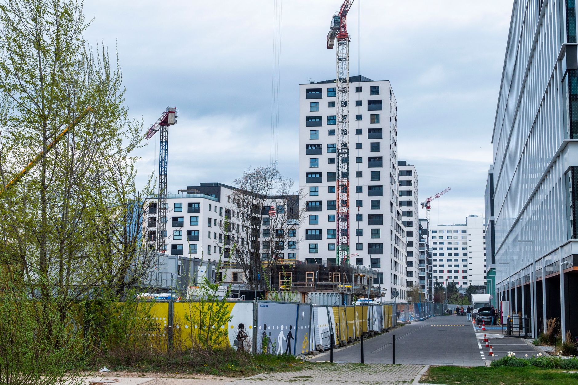 Construction workers on social housing site with crane in background