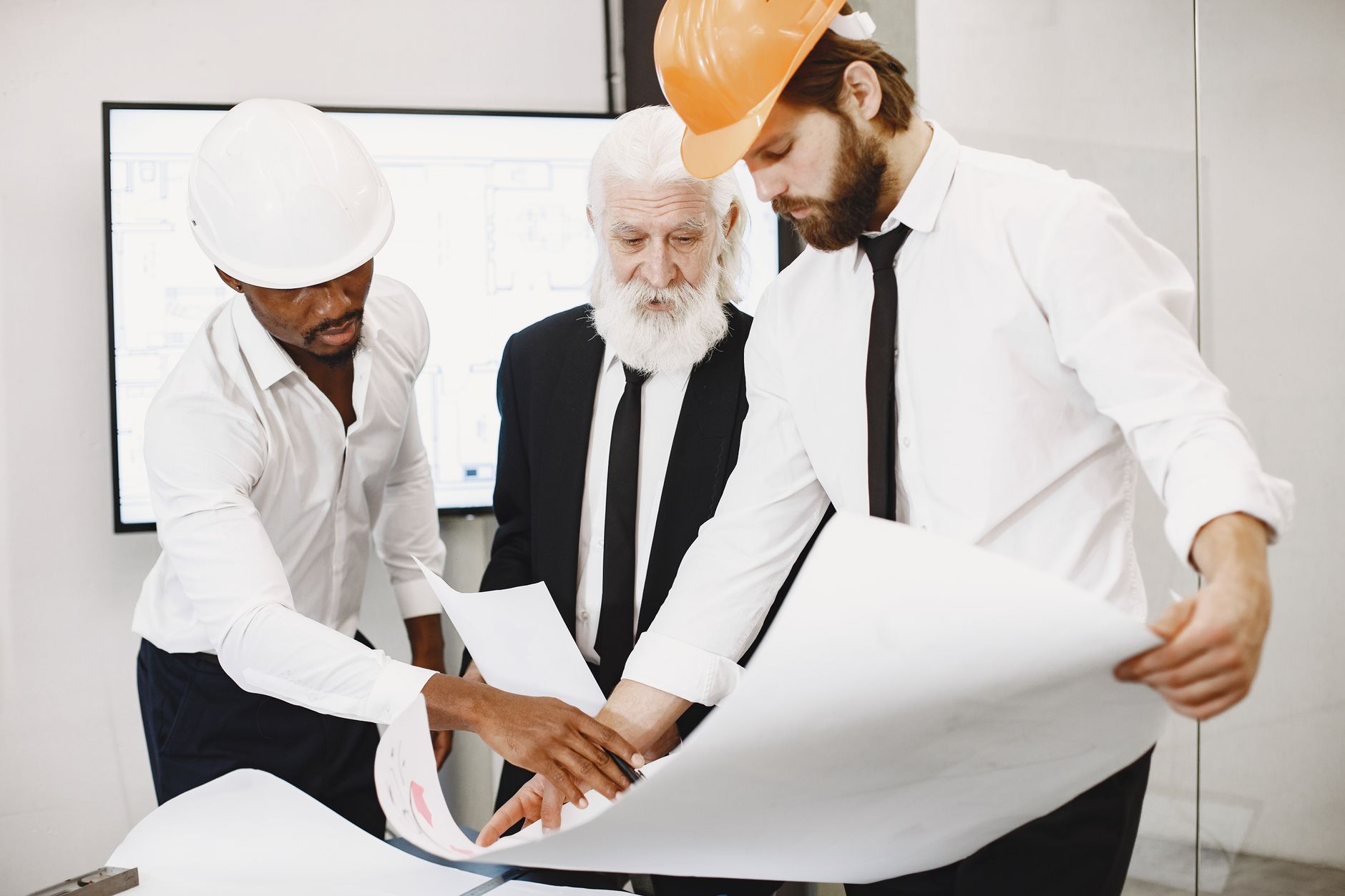 Architects and housing officers reviewing plans together