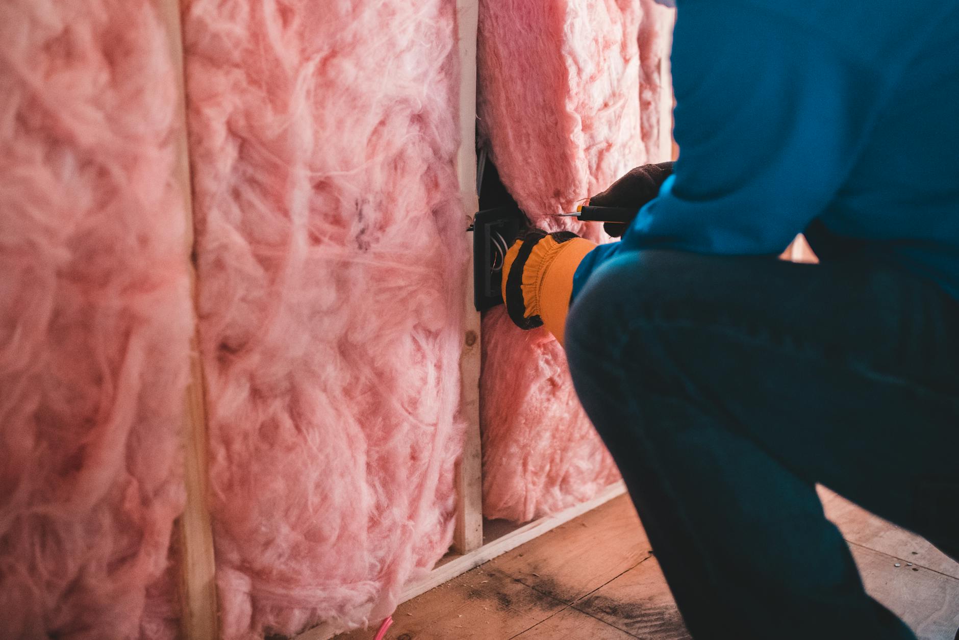 Workers installing energy-efficient housing insulation