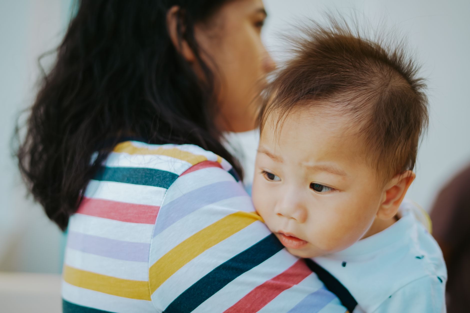 Distressed mother holding baby in temporary accommodation