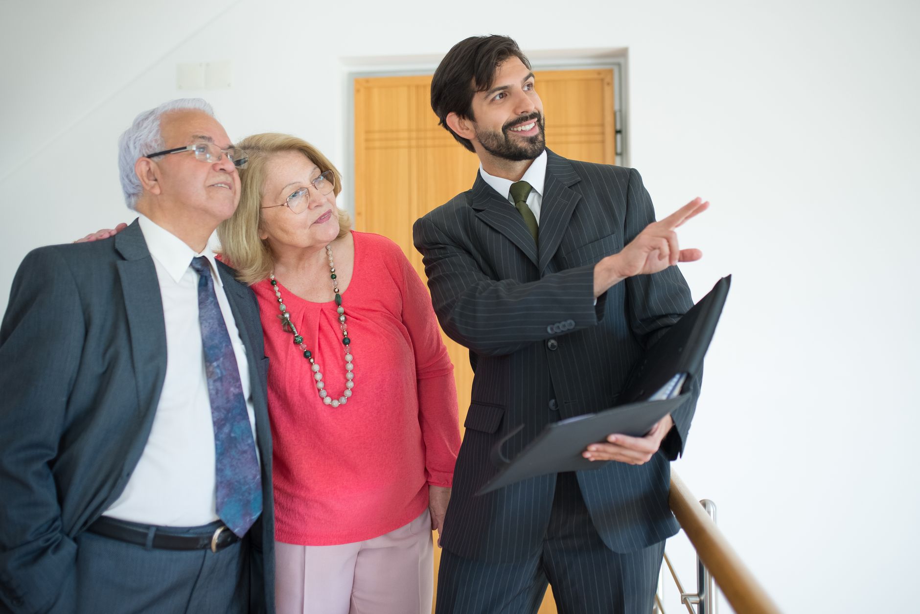 Elderly couple looking at rental property with housing officer