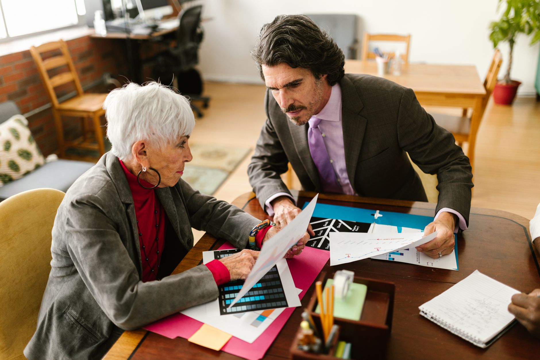 Housing officer reviewing documents with elderly tenant