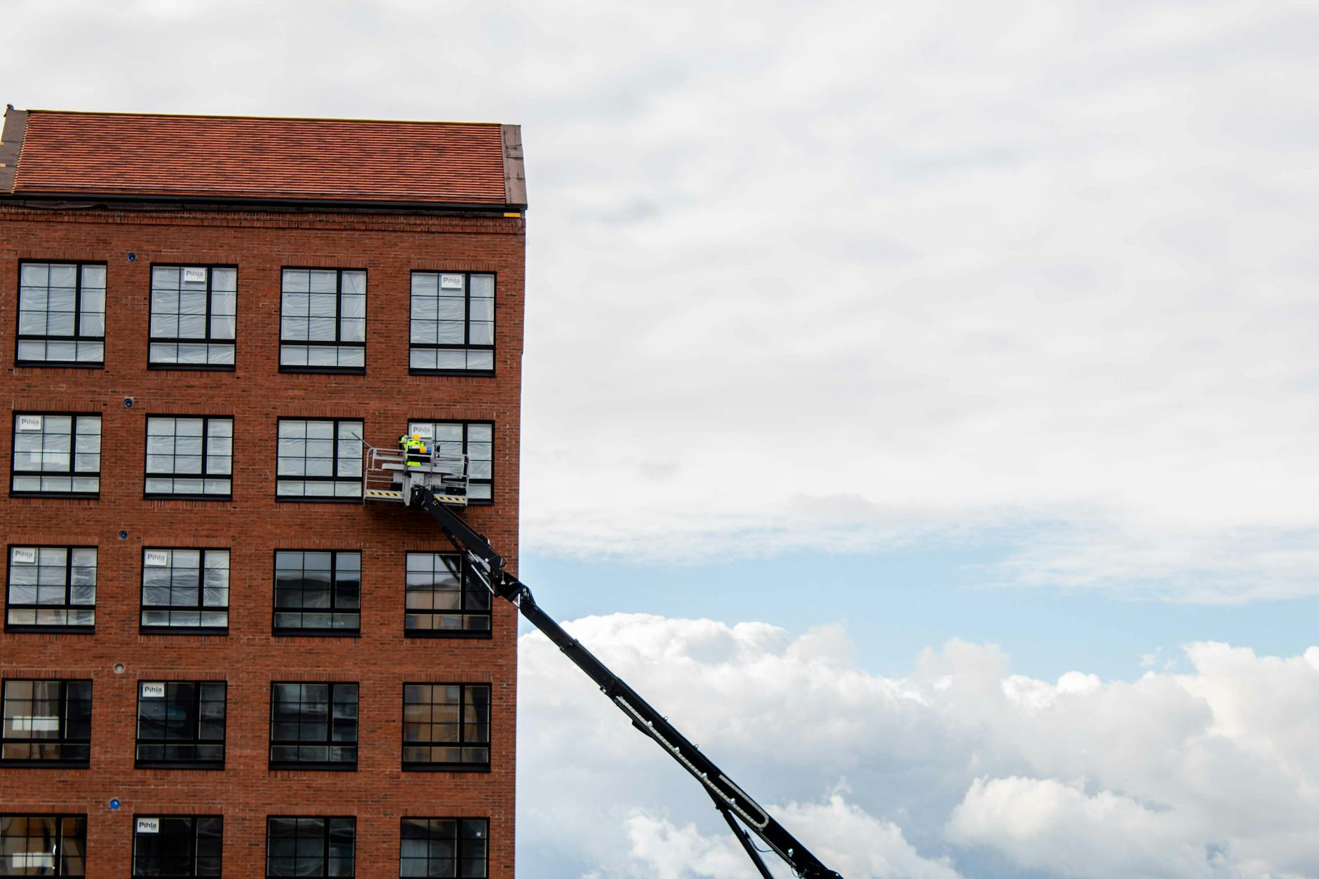 Construction worker inspecting building facade