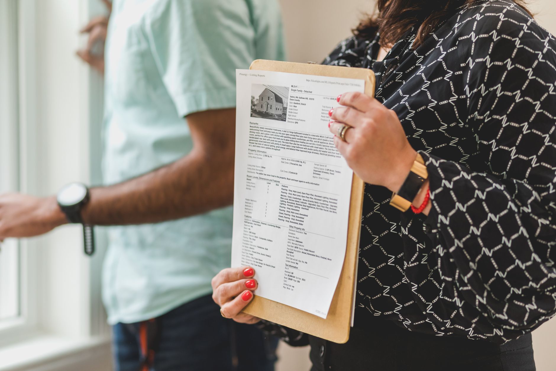 Housing officer inspecting property - alt text: Housing officer conducting property inspection with clipboard