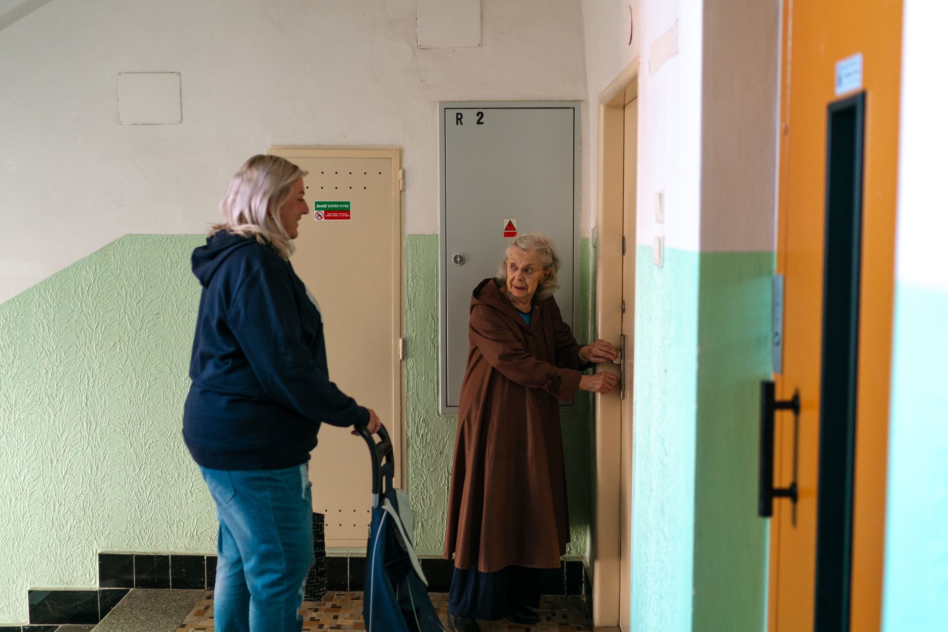 Vulnerable resident in supported housing - alt text: Elderly resident receiving support in communal housing area