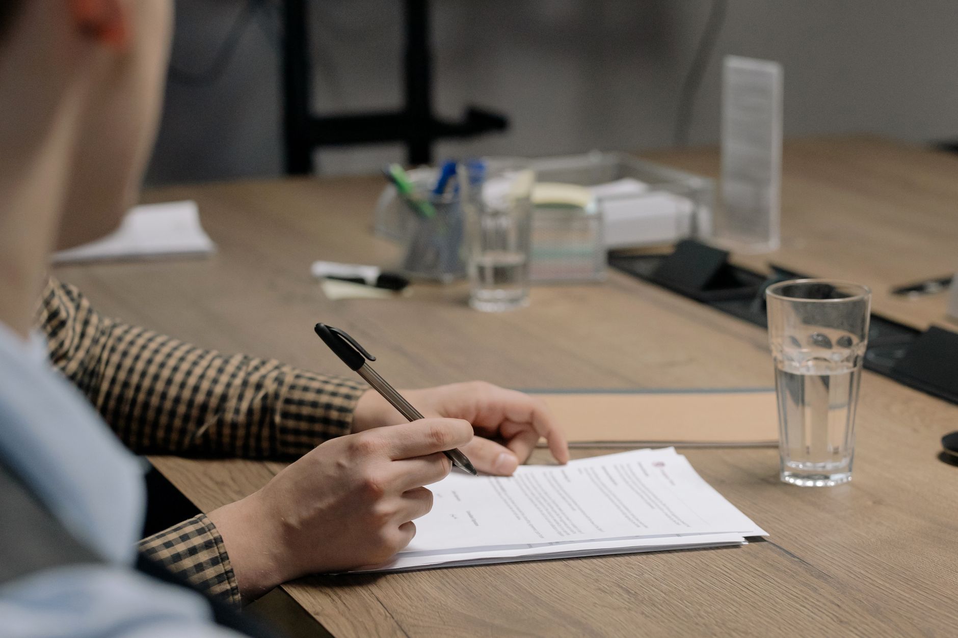 Regulatory judgement documents on a desk with a pen