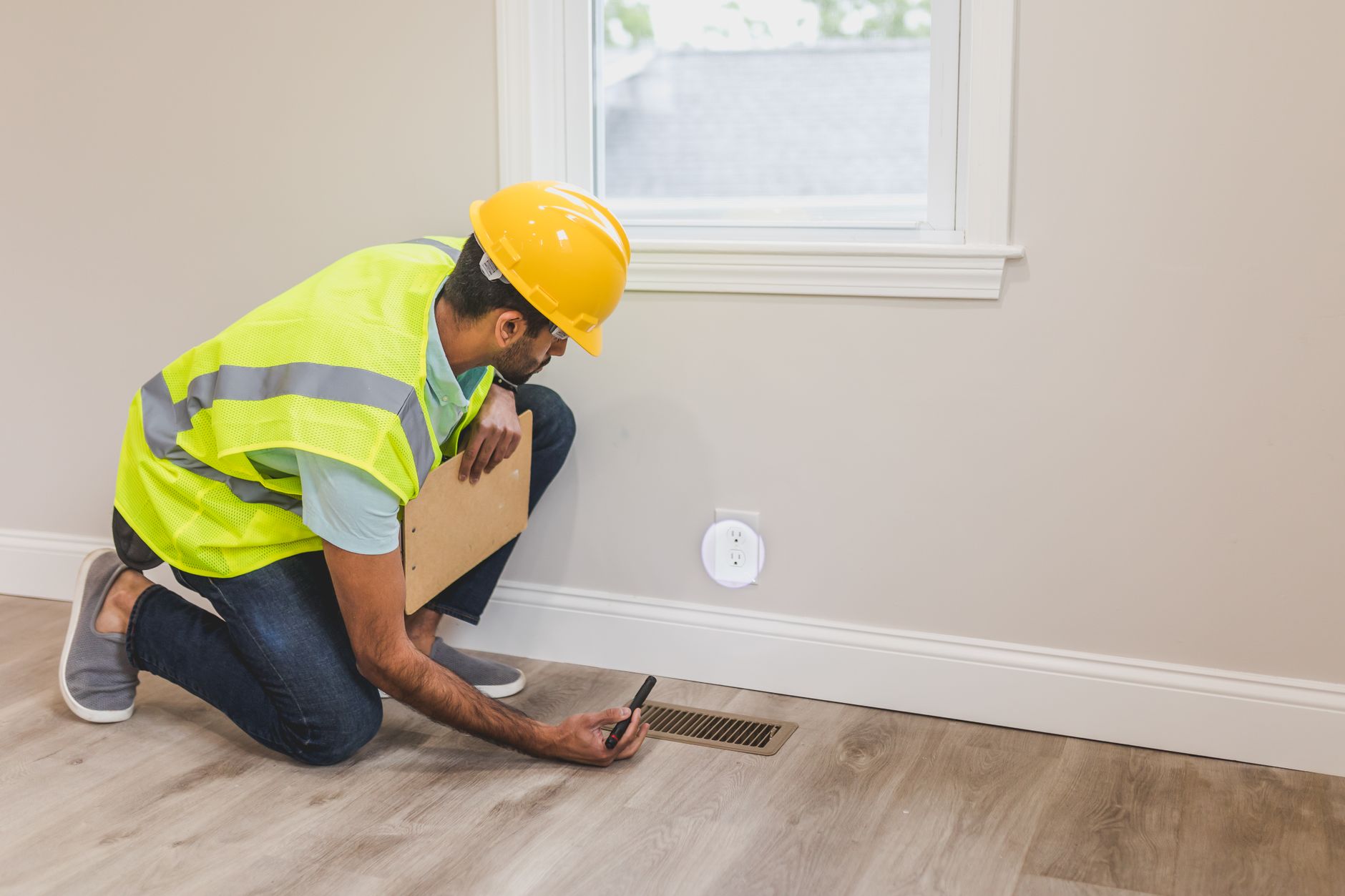 Housing association worker inspecting property ventilation
