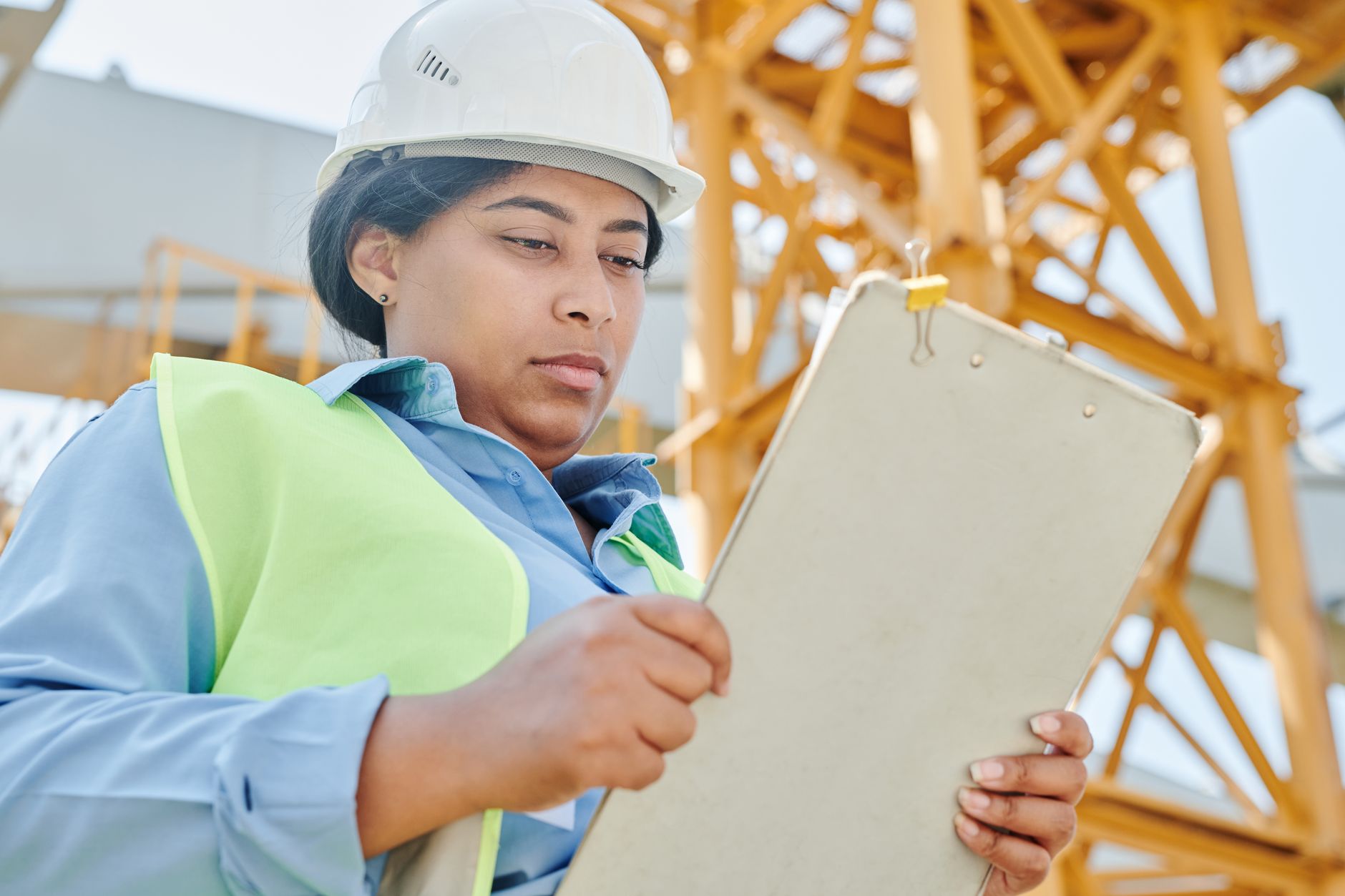 Construction worker inspecting building cladding up close