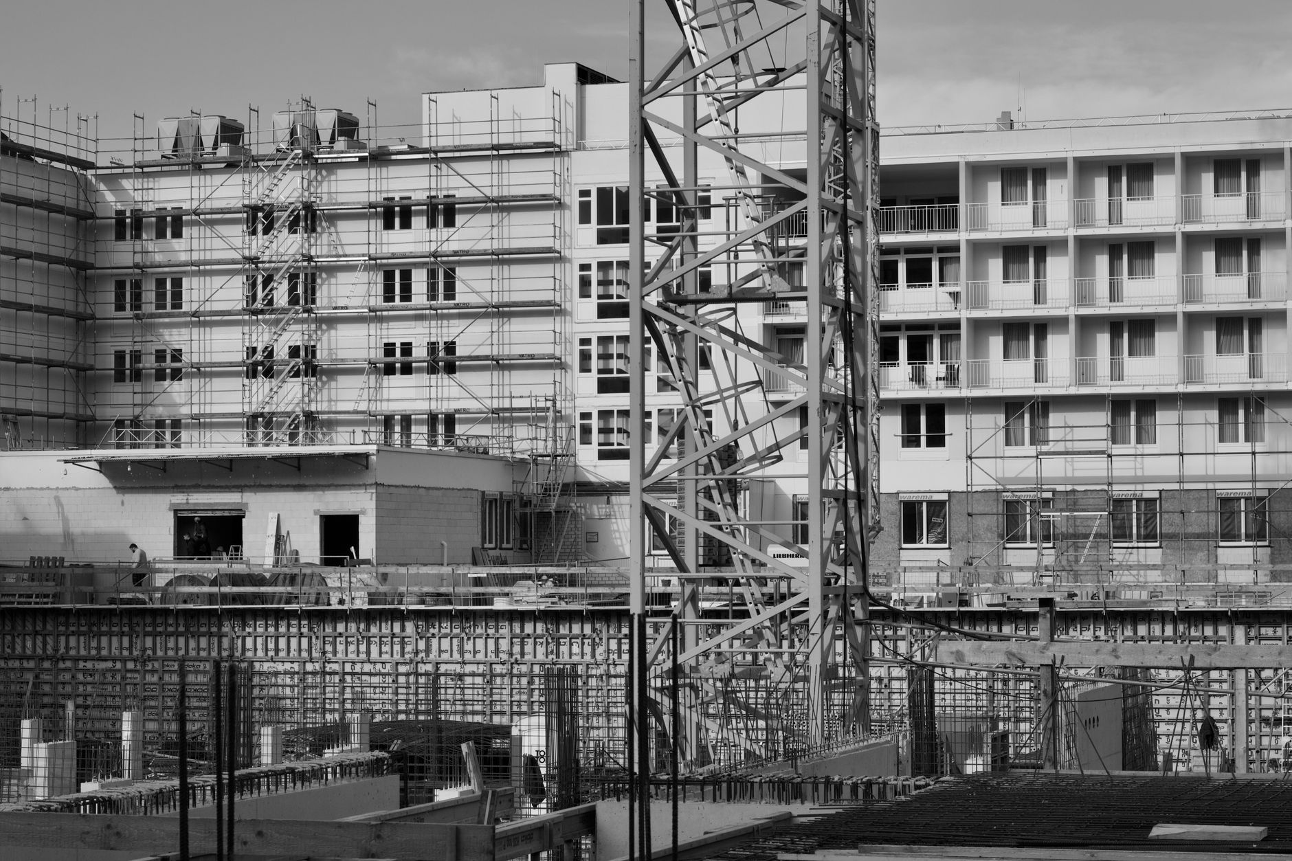 New housing development under construction - cranes and workers on site