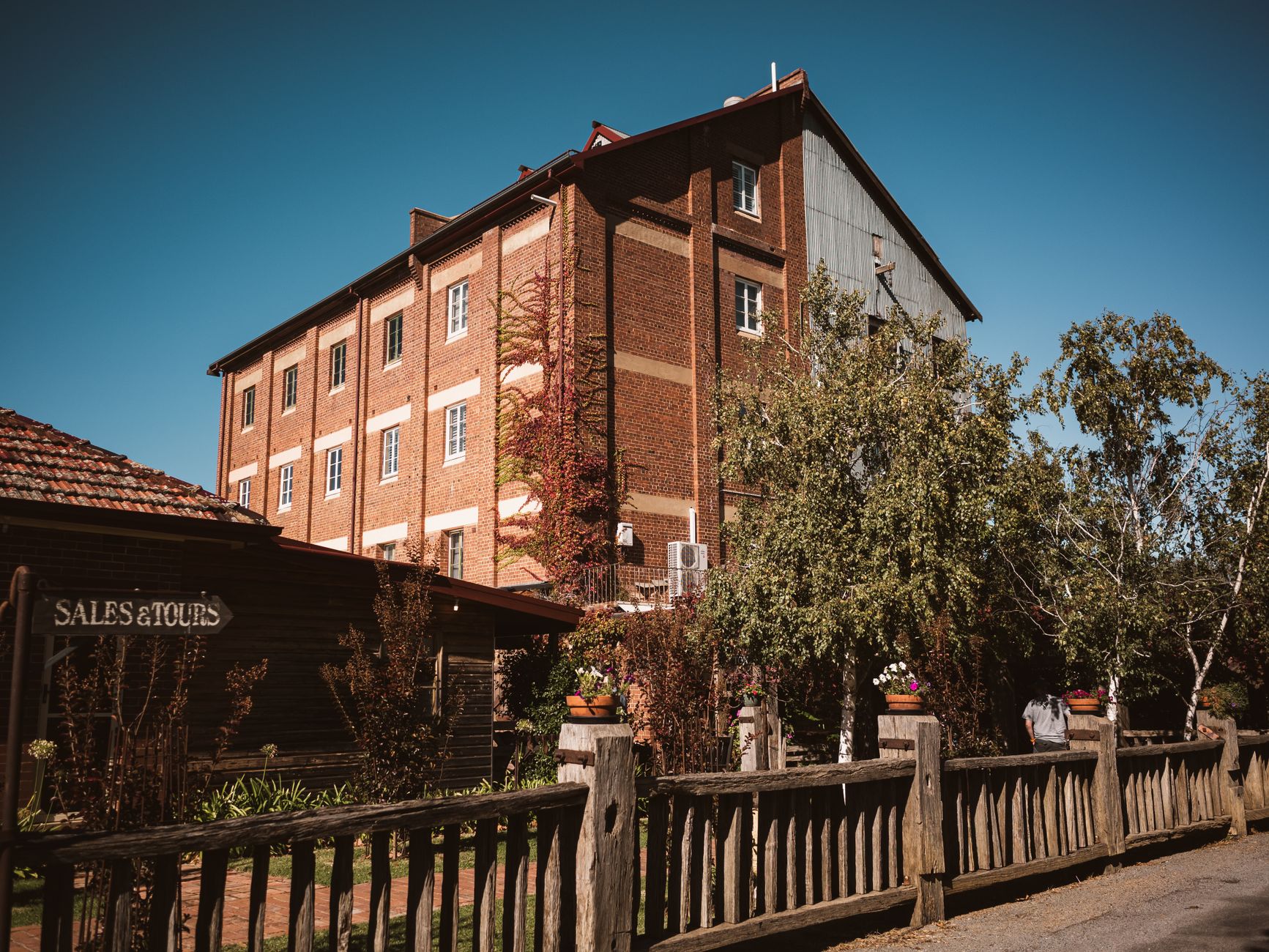 Historic hotel building exterior with 'For Sale' sign