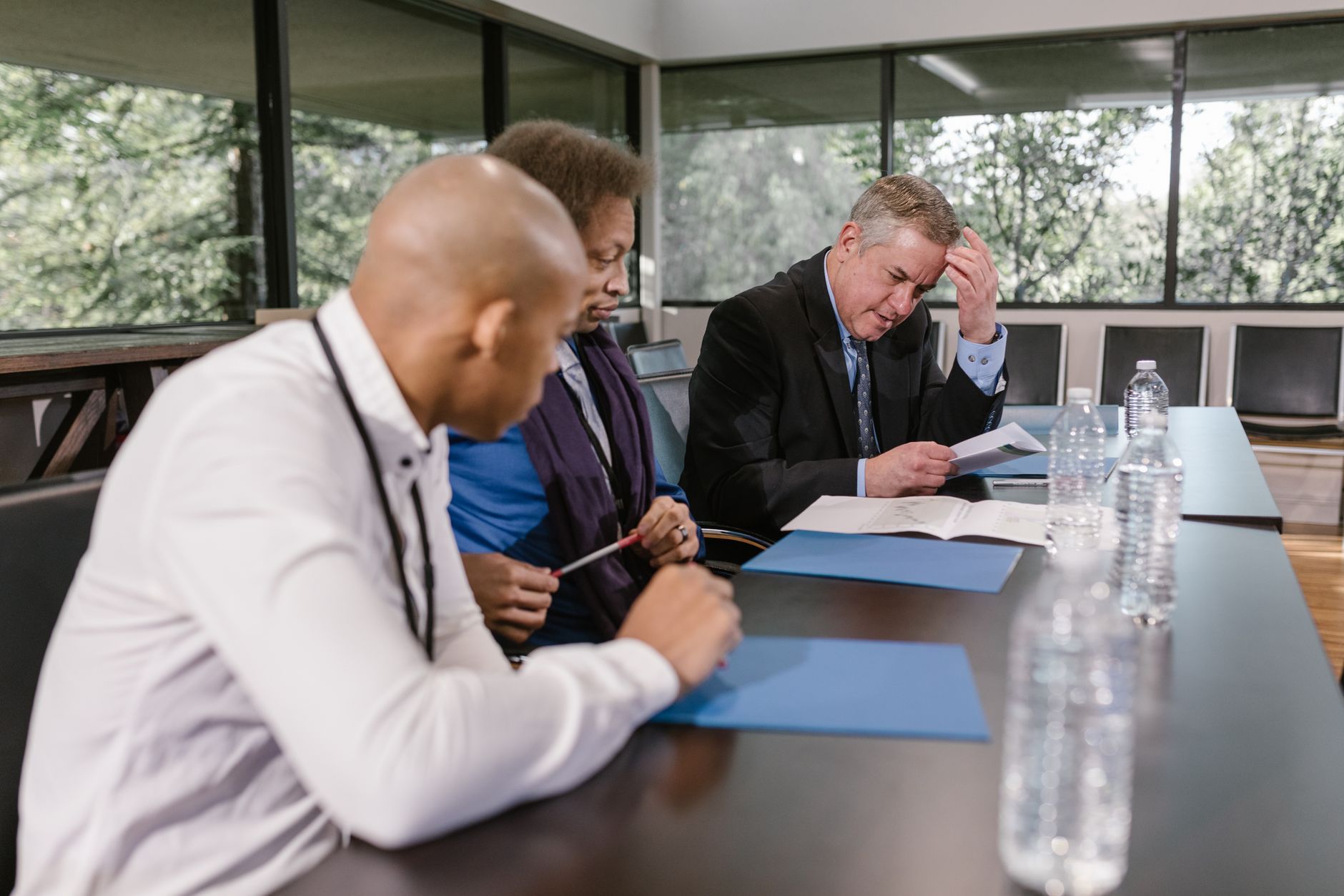 Team of housing professionals discussing documents in a meeting room