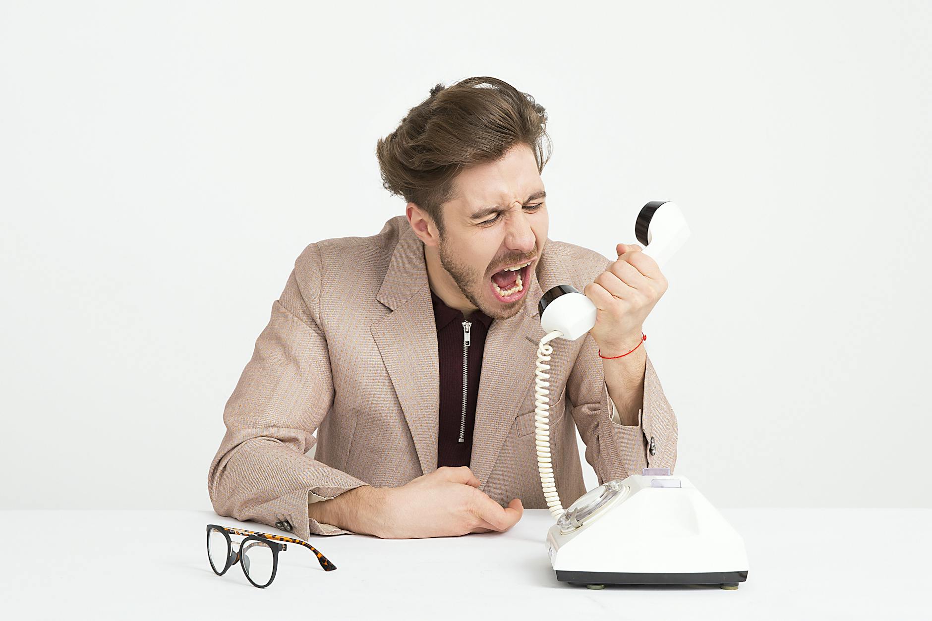 Angry tenant speaking with letting agent in office - depicting tenant frustration