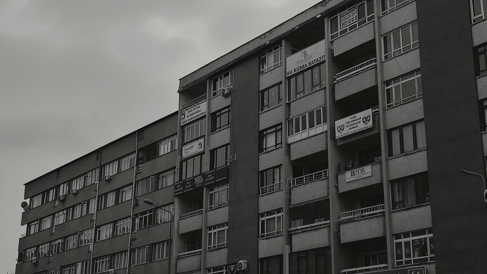 Modern apartment building with social housing signage